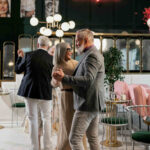 an old couple at an event slow dance, sway and serenade