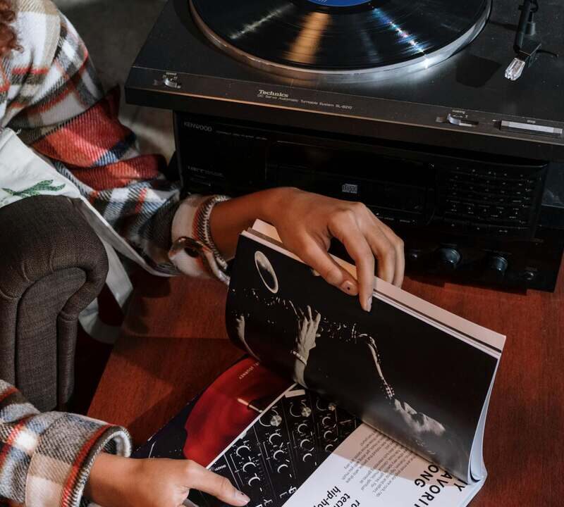 person with a booklet and turntable learning how to unlock the booth