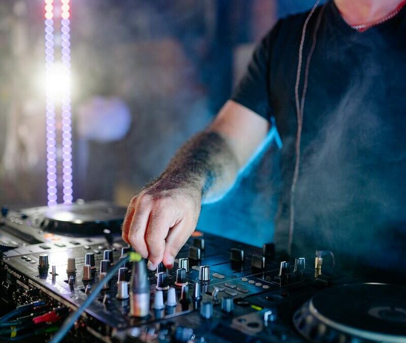 DJ on club stage engaging in energy management