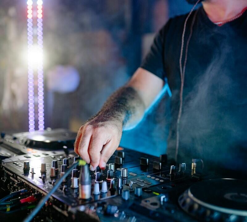 DJ on club stage engaging in energy management