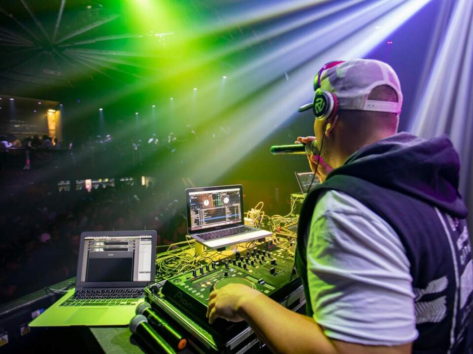 5 Simple Tips to Conquer Mic Fear illustrated by a dj using a mic during a club set