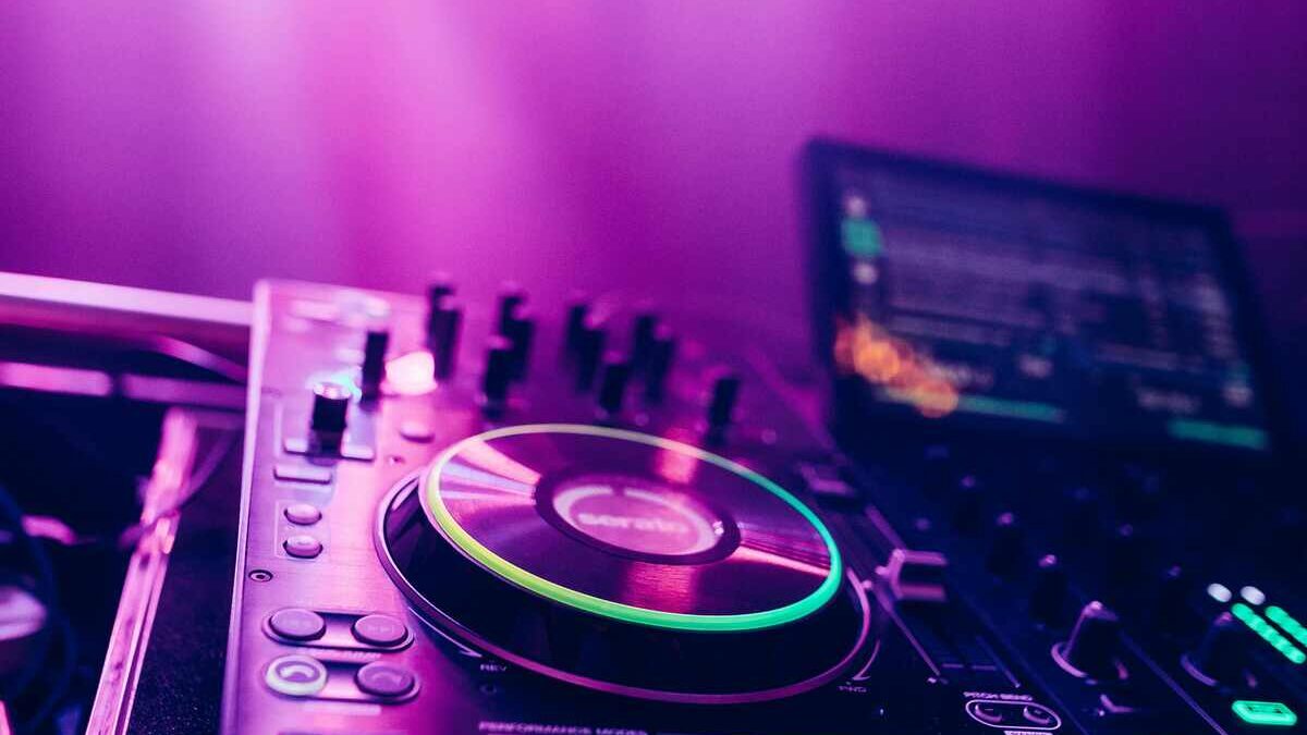 Behind-the-scenes wedding DJ setup with sound equipment, lighting, and cables being prepared before guests arrive to create the perfect atmosphere.