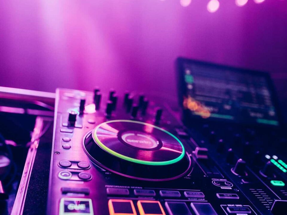 Behind-the-scenes wedding DJ setup with sound equipment, lighting, and cables being prepared before guests arrive to create the perfect atmosphere.