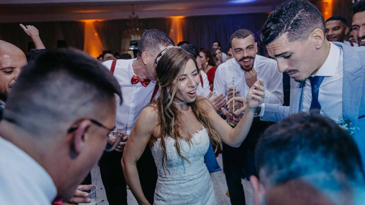Wedding DJ performing at a wedding reception, setting up sound and lighting to create the perfect atmosphere for guests.