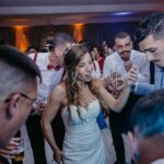 Wedding DJ performing at a wedding reception, setting up sound and lighting to create the perfect atmosphere for guests.