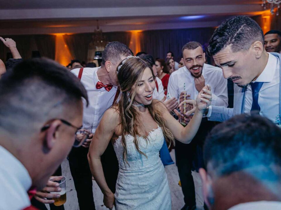 Wedding DJ performing at a wedding reception, setting up sound and lighting to create the perfect atmosphere for guests.